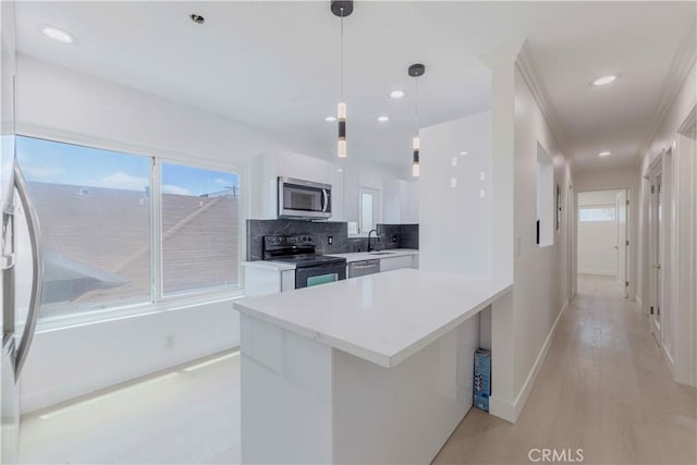 645 N Gramercy Pl, Los Angeles, CA 90004 - kitchen featuring stainless steel appliances, modern cabinets, white cabinetry, tasteful backsplash, and healthy amount of natural light