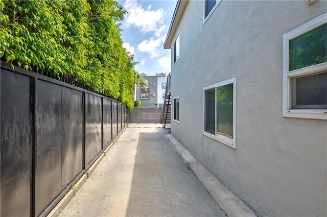 645 N Gramercy Pl, Los Angeles, CA 90004 - view of property exterior featuring stucco siding, a fenced backyard, and a patio area