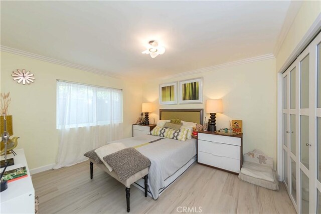 645 N Gramercy Pl, Los Angeles, CA 90004 - bedroom featuring crown molding, light wood-type flooring, and a closet