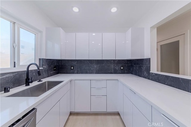 645 N Gramercy Pl, Los Angeles, CA 90004 - kitchen with modern cabinets, white cabinets, stainless steel dishwasher, decorative backsplash, and recessed lighting