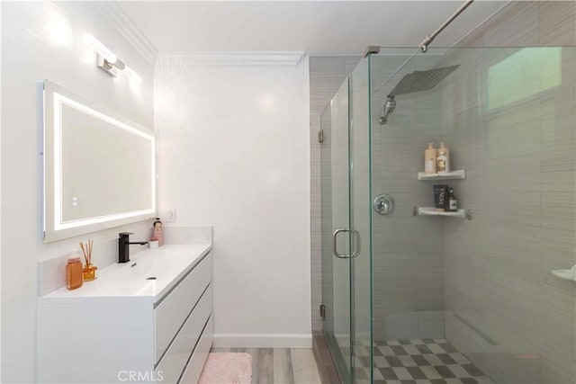 645 N Gramercy Pl, Los Angeles, CA 90004 - bathroom featuring vanity, a shower stall, crown molding, and wood finished floors