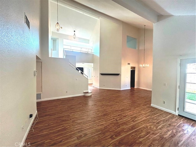 12180 Westerly Trl, Moreno Valley, CA 92557 - unfurnished living room featuring high vaulted ceiling, a chandelier, and wood finished floors