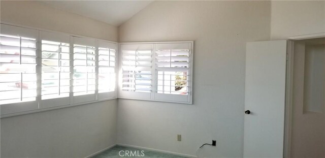 12180 Westerly Trl, Moreno Valley, CA 92557 - spare room with lofted ceiling and baseboards
