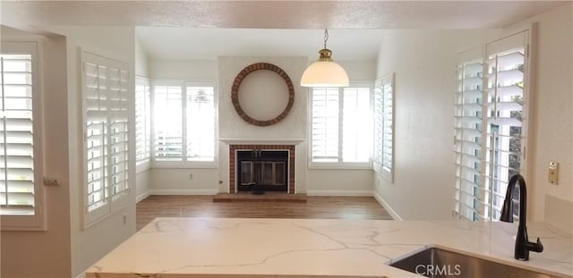 12180 Westerly Trl, Moreno Valley, CA 92557 - unfurnished living room featuring wood finished floors and a fireplace
