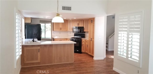 12180 Westerly Trl, Moreno Valley, CA 92557 - kitchen with black appliances, a peninsula, wood finished floors, light countertops, and pendant lighting
