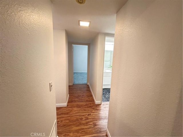 12180 Westerly Trl, Moreno Valley, CA 92557 - corridor featuring a textured wall and wood finished floors