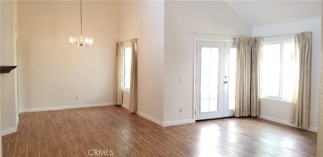 12180 Westerly Trl, Moreno Valley, CA 92557 - foyer featuring plenty of natural light, a chandelier, wood finished floors, and high vaulted ceiling