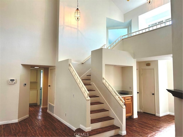 12180 Westerly Trl, Moreno Valley, CA 92557 - staircase featuring a towering ceiling and wood finished floors