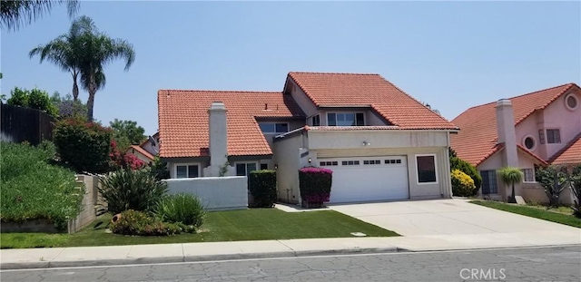 12180 Westerly Trl, Moreno Valley, CA 92557 - mediterranean / spanish home featuring a tile roof, driveway, an attached garage, and stucco siding