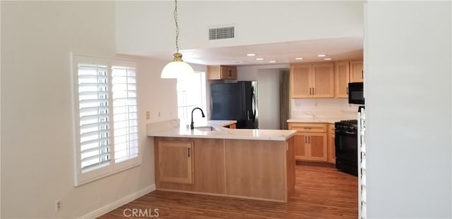 12180 Westerly Trl, Moreno Valley, CA 92557 - kitchen featuring black appliances, light countertops, a peninsula, a high ceiling, and wood finished floors