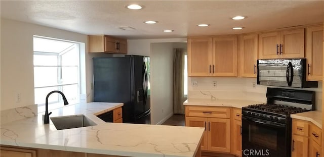 12180 Westerly Trl, Moreno Valley, CA 92557 - kitchen with black appliances, light stone counters, a peninsula, and recessed lighting