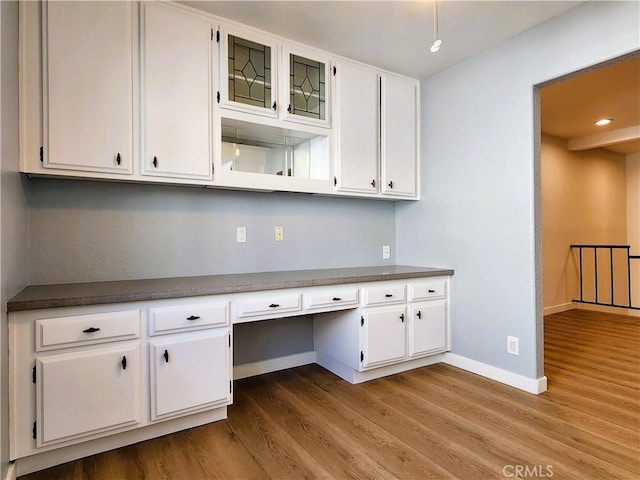 10201 Mason Ave Unit 34, Chatsworth, CA 91311 - kitchen featuring built in desk, wood finished floors, white cabinetry, dark countertops, and recessed lighting