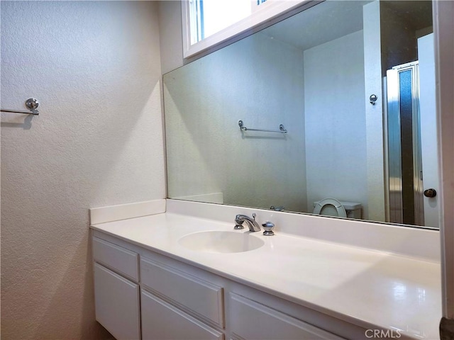 10201 Mason Ave Unit 34, Chatsworth, CA 91311 - bathroom featuring a textured wall, vanity, and an enclosed shower