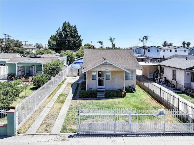 430 E 104th St, Los Angeles, CA 90003 - bungalow-style house with stucco siding, a fenced front yard, a shingled roof, a gate, and a residential view