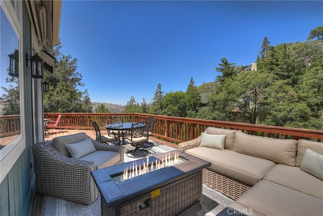 1179 Aleutian Dr, Lake Arrowhead, CA 92352 - wooden deck featuring an outdoor living space with a fire pit