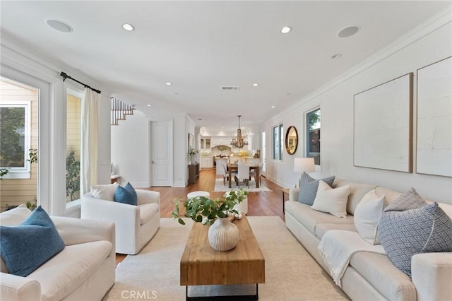 3201 4th Ave, Corona Del Mar, CA 92625 - living room featuring recessed lighting, light wood-style flooring, crown molding, and a chandelier
