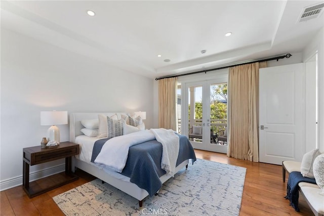 3201 4th Ave, Corona Del Mar, CA 92625 - bedroom with access to outside, french doors, wood finished floors, a tray ceiling, and recessed lighting