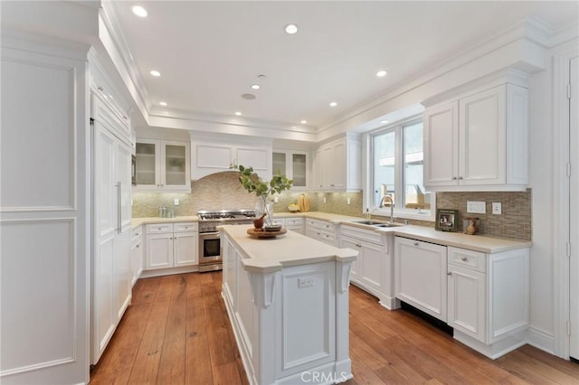3201 4th Ave, Corona Del Mar, CA 92625 - kitchen with high end stove, white cabinetry, a kitchen island, decorative backsplash, and ornamental molding