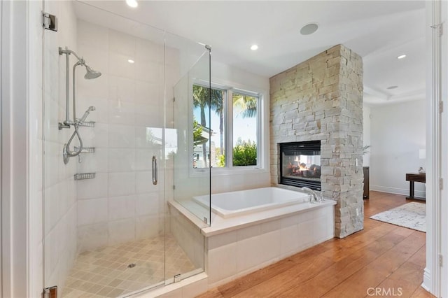 3201 4th Ave, Corona Del Mar, CA 92625 - full bathroom with hardwood / wood-style floors, a stall shower, a bath, a stone fireplace, and recessed lighting