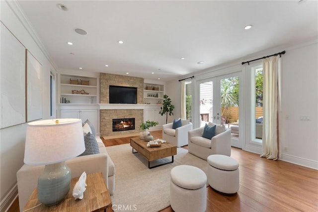 3201 4th Ave, Corona Del Mar, CA 92625 - living room with a stone fireplace, built in shelves, light wood finished floors, recessed lighting, and crown molding