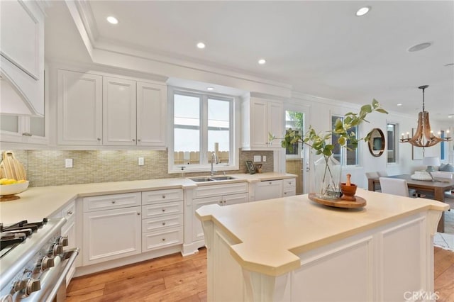 3201 4th Ave, Corona Del Mar, CA 92625 - kitchen featuring high end stainless steel range oven, ornamental molding, white cabinets, tasteful backsplash, and recessed lighting
