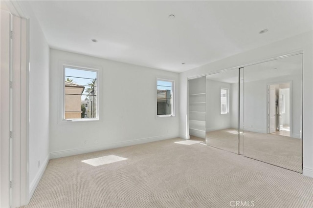 3201 4th Ave, Corona Del Mar, CA 92625 - unfurnished bedroom featuring light colored carpet, multiple windows, and a closet
