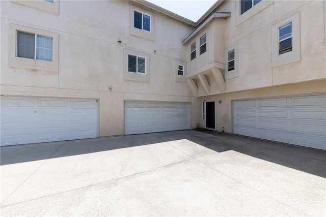 23220 Colony Park Dr, Carson, CA 90745 - rear view of house with stucco siding, a garage, and concrete driveway