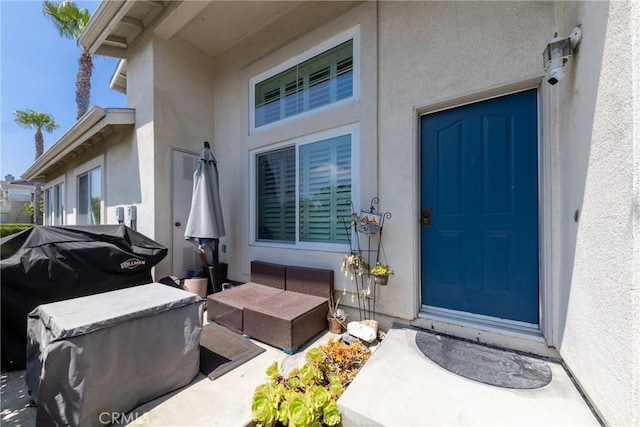 23220 Colony Park Dr, Carson, CA 90745 - view of exterior entry with stucco siding, an outdoor living space, and a patio