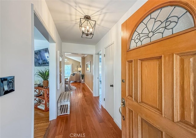 10424 Gloria Ave, Granada Hills, CA 91344 - foyer with wood finished floors and a chandelier