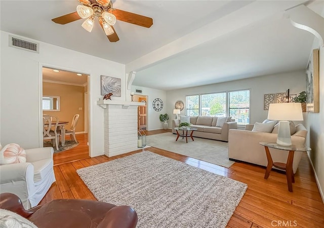 10424 Gloria Ave, Granada Hills, CA 91344 - living room with healthy amount of natural light, light wood-type flooring, ceiling fan, and a fireplace