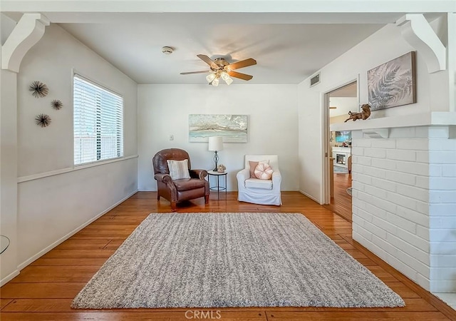 10424 Gloria Ave, Granada Hills, CA 91344 - sitting room featuring wood finished floors, ceiling fan, and a fireplace