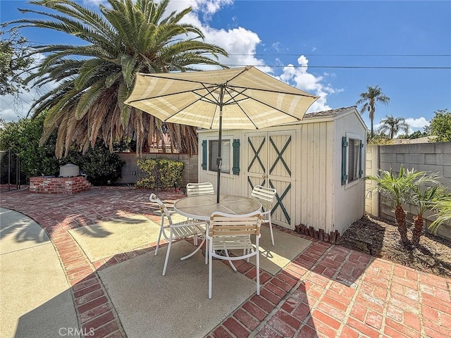 10424 Gloria Ave, Granada Hills, CA 91344 - fenced backyard featuring a patio, an outdoor structure, and outdoor dining area