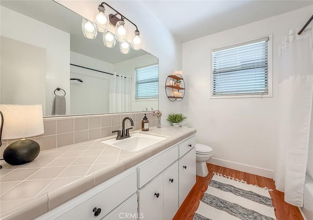 10424 Gloria Ave, Granada Hills, CA 91344 - bathroom featuring vanity, wood finished floors, a shower with shower curtain, and decorative backsplash