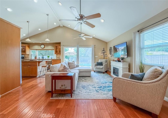 10424 Gloria Ave, Granada Hills, CA 91344 - living area featuring light wood-style flooring, a ceiling fan, recessed lighting, high vaulted ceiling, and a glass covered fireplace