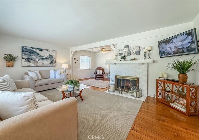 10424 Gloria Ave, Granada Hills, CA 91344 - living area featuring wood-type flooring, a fireplace, and ceiling fan