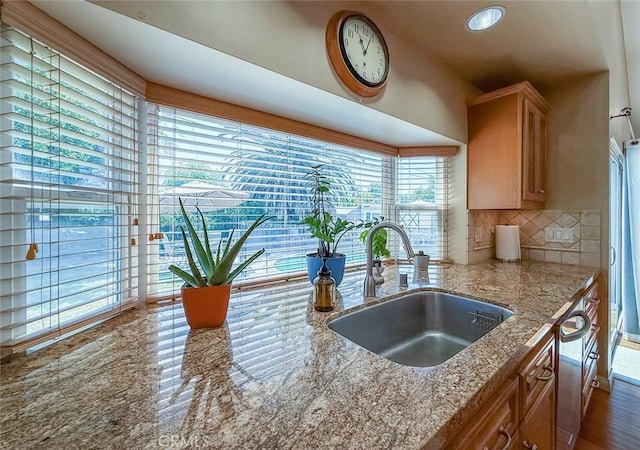 10424 Gloria Ave, Granada Hills, CA 91344 - kitchen featuring decorative backsplash, light stone countertops, and stainless steel dishwasher