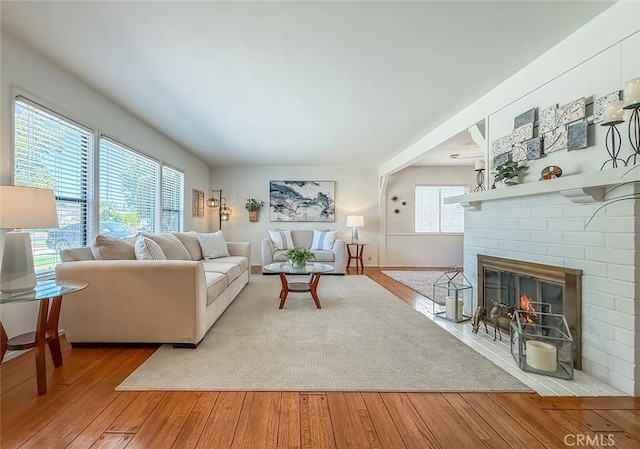 10424 Gloria Ave, Granada Hills, CA 91344 - living room with hardwood / wood-style floors and a brick fireplace