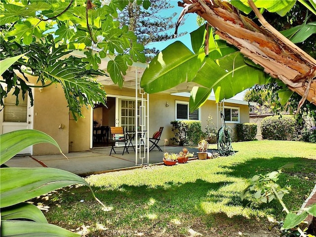 2524 Littleton Pl, Costa Mesa, CA 92626 - rear view of house with stucco siding, a patio area, and a yard
