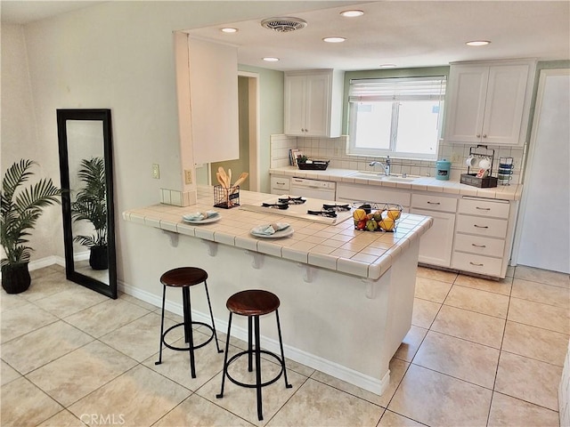 2524 Littleton Pl, Costa Mesa, CA 92626 - kitchen featuring a kitchen breakfast bar, tile countertops, backsplash, light tile patterned flooring, and recessed lighting