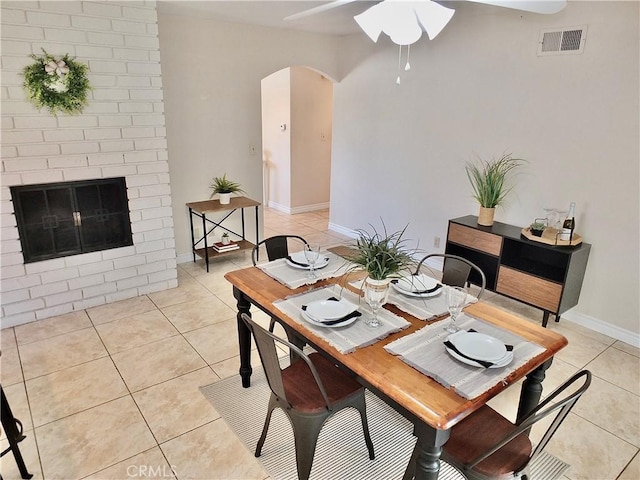 2524 Littleton Pl, Costa Mesa, CA 92626 - dining space with ceiling fan, arched walkways, light tile patterned floors, and a fireplace