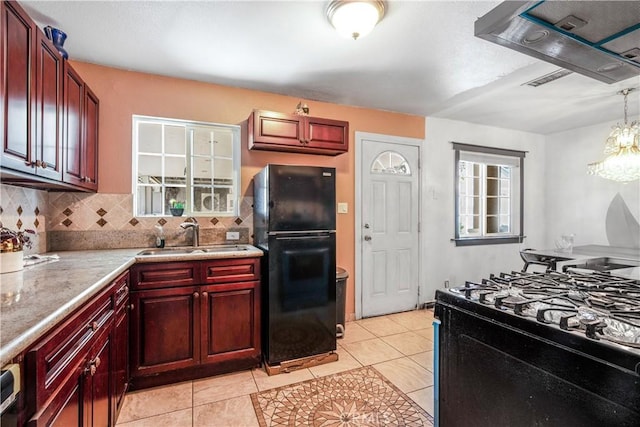 7549 Variel Ave, Canoga Park, CA 91303 - kitchen with black appliances, dark brown cabinets, tasteful backsplash, light countertops, and light tile patterned floors