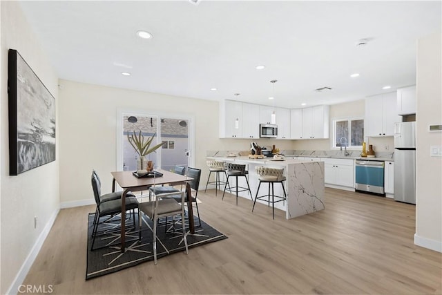 3876 Olmsted Ave, Los Angeles, CA 90008 - dining area featuring light wood finished floors and recessed lighting