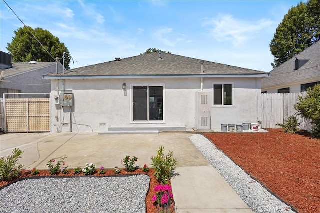 3876 Olmsted Ave, Los Angeles, CA 90008 - rear view of property featuring stucco siding, roof with shingles, and a patio area