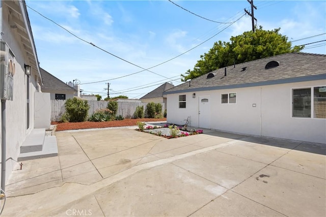 3876 Olmsted Ave, Los Angeles, CA 90008 - back of house with a patio area, stucco siding, and roof with shingles