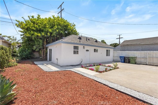 3876 Olmsted Ave, Los Angeles, CA 90008 - back of property with stucco siding, a patio area, and a shingled roof