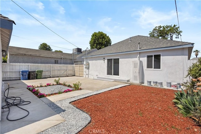 3876 Olmsted Ave, Los Angeles, CA 90008 - back of house featuring stucco siding, a patio area, and roof with shingles