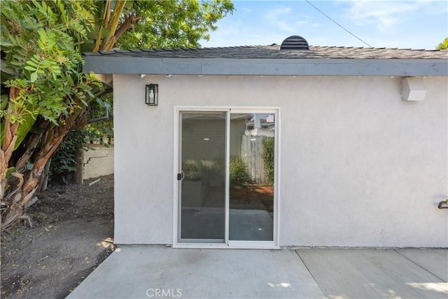 3876 Olmsted Ave, Los Angeles, CA 90008 - doorway to property with a patio, stucco siding, and roof with shingles