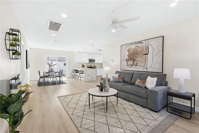 3876 Olmsted Ave, Los Angeles, CA 90008 - living area featuring light wood finished floors, recessed lighting, and ceiling fan