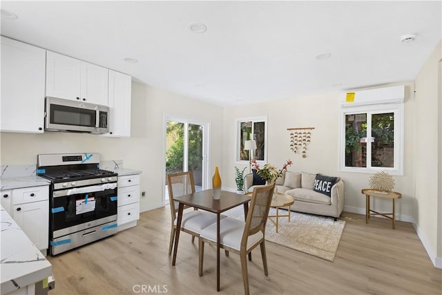3876 Olmsted Ave, Los Angeles, CA 90008 - kitchen featuring stainless steel appliances, light wood finished floors, and white cabinets