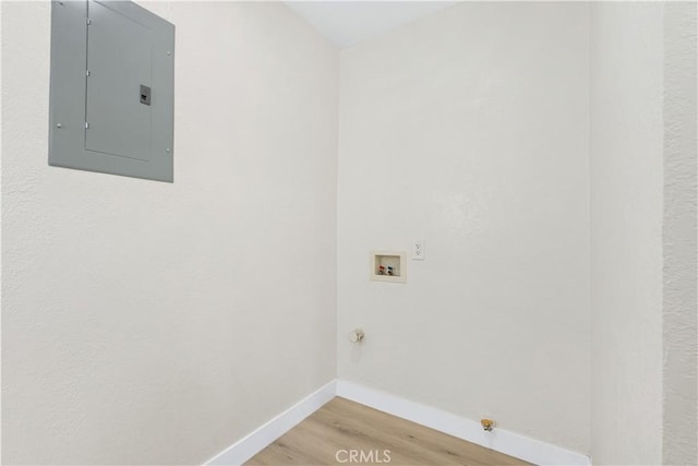 3876 Olmsted Ave, Los Angeles, CA 90008 - washroom featuring electric panel, light wood finished floors, hookup for a gas dryer, and hookup for a washing machine